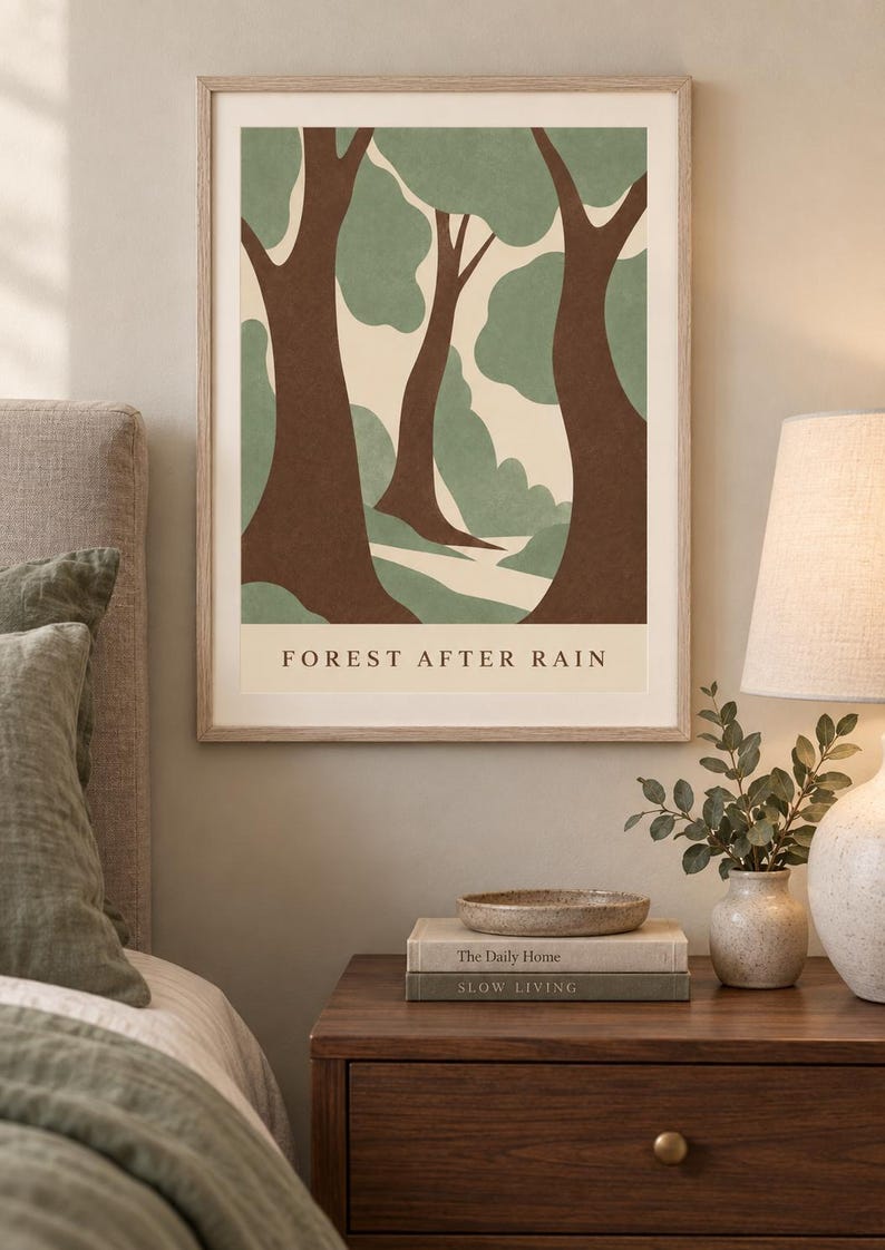 May include: A framed wall art print titled FOREST AFTER RAIN featuring a stylized illustration of trees with brown trunks and sage green foliage against a cream background. The artwork is displayed in a light wood frame with a clean, simple border.