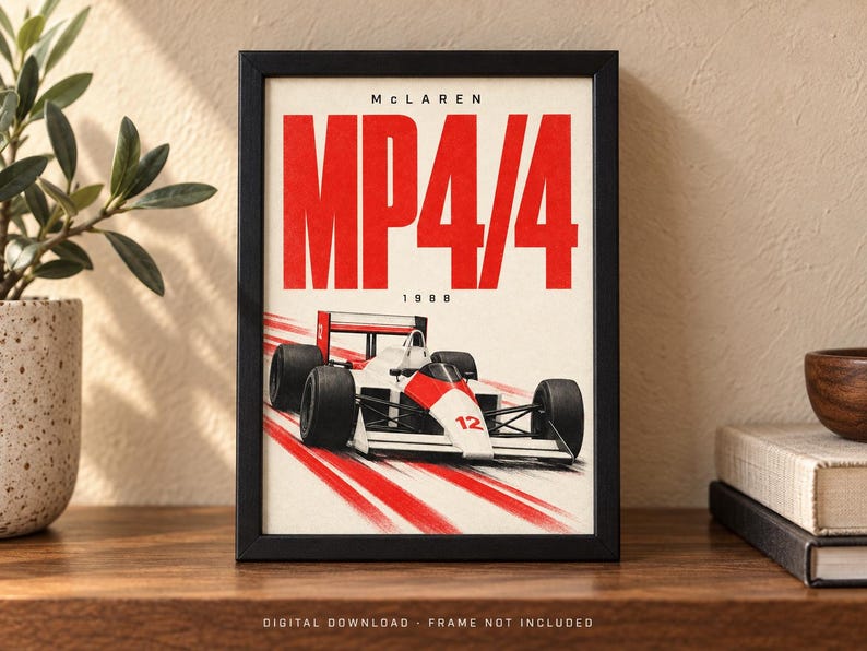 May include: A framed poster featuring a white and red McLaren MP4/4 Formula 1 race car from 1988. The text reads McLaren MP4/4 1988 in bold red and black lettering. The car is depicted in motion with red speed lines on a white background.
