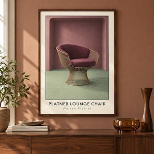 May include: A framed wall art print featuring a Platner lounge chair with a deep purple upholstered seat and a gold-toned wire base. The chair is set against a muted pink archway and a light green floor. The text reads Platner Lounge Chair Warren Platner.