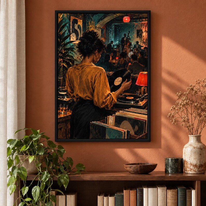 May include: A framed wall art print depicting a person in a mustard yellow shirt and black skirt standing at a turntable, holding a vinyl record. The scene shows a dimly lit jazz club with musicians in the background, a red lamp, and record crates.