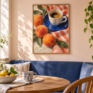May include: A framed wall art print depicting a still life scene with three ripe orange peaches, green leaves, and a white coffee cup resting on a vibrant blue saucer, all set upon a red and white checkered cloth with a textured surface.
