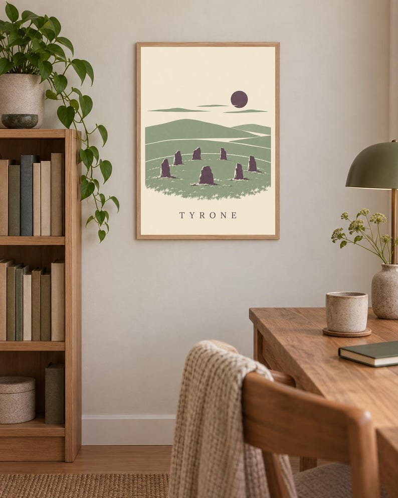 May include: A framed rectangular wall art print featuring a stylized landscape illustration of a stone circle in a green field under a dark sun, with the text TYRONE printed in black capital letters at the bottom center of the cream background.