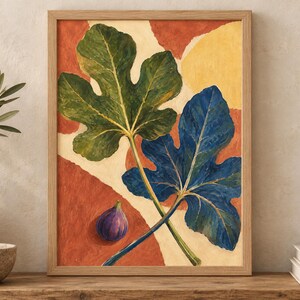 May include: A framed wall art print featuring a painting of two large fig leaves, one green and one deep blue, alongside a single purple fig. The background consists of abstract shapes in shades of terracotta orange and cream, set in a light wood frame.