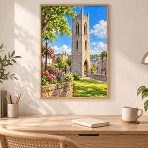 May include: A framed wall art print depicting a tall, weathered stone bell tower under a bright blue sky. The scene includes a lush green lawn, a stone wall, vibrant pink and purple flowers, a black lamppost, and distant buildings in the background.