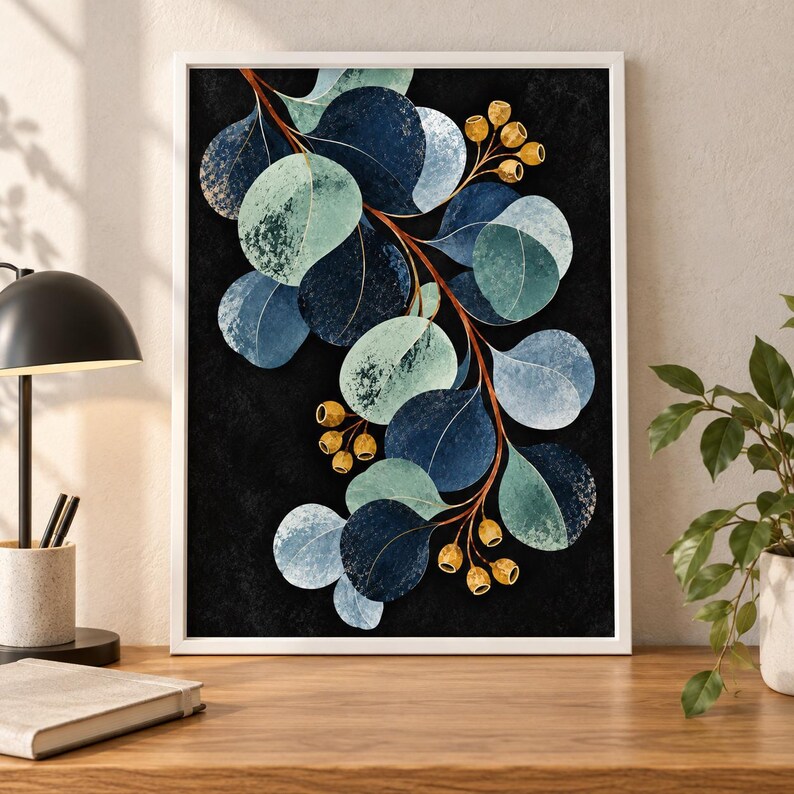 May include: A framed wall art print featuring a botanical illustration of eucalyptus branches with rounded leaves in shades of navy blue, teal, and light green, accented by small golden seed pods against a solid black background.