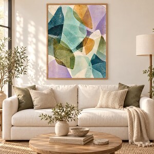 May include: A rectangular wall art piece featuring an abstract composition of overlapping organic shapes in shades of teal, olive green, mustard yellow, and soft lavender, all enclosed within a light-toned wooden frame hanging on a wall.