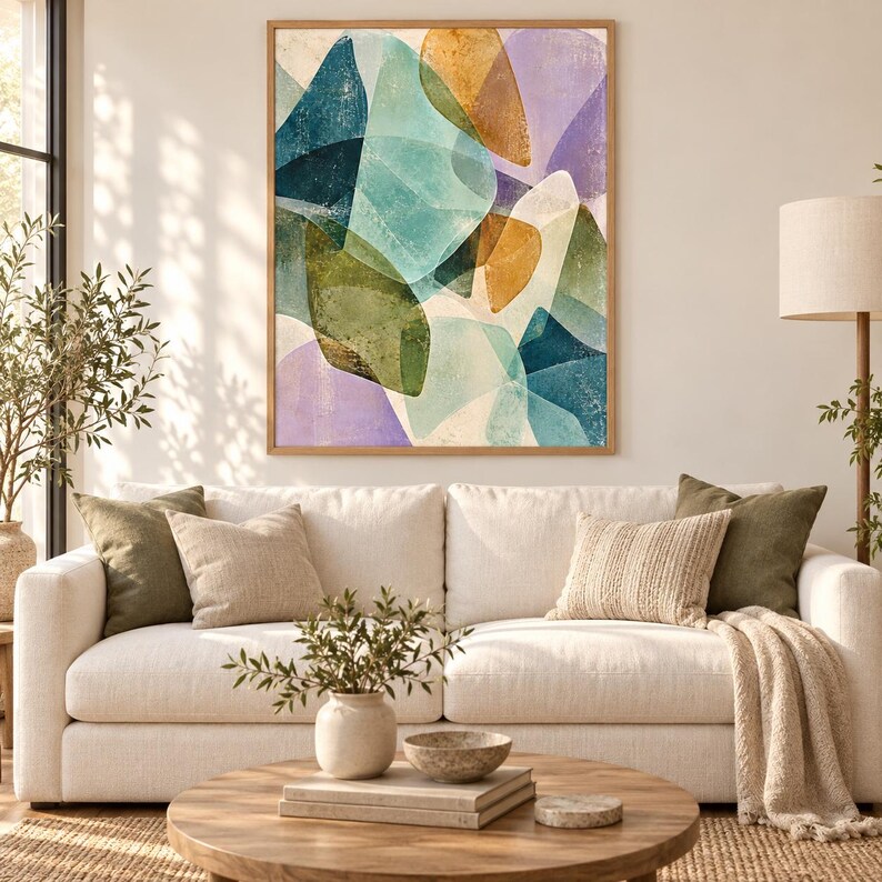 May include: A rectangular wall art piece featuring an abstract composition of overlapping organic shapes in shades of teal, olive green, mustard yellow, and soft lavender, all enclosed within a light-toned wooden frame hanging on a wall.