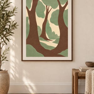 May include: A framed wall art print featuring a stylized forest scene with dark brown tree trunks, soft sage green foliage, and a cream-colored background. The artwork is enclosed in a thin, dark brown wooden frame and displayed on a wall.