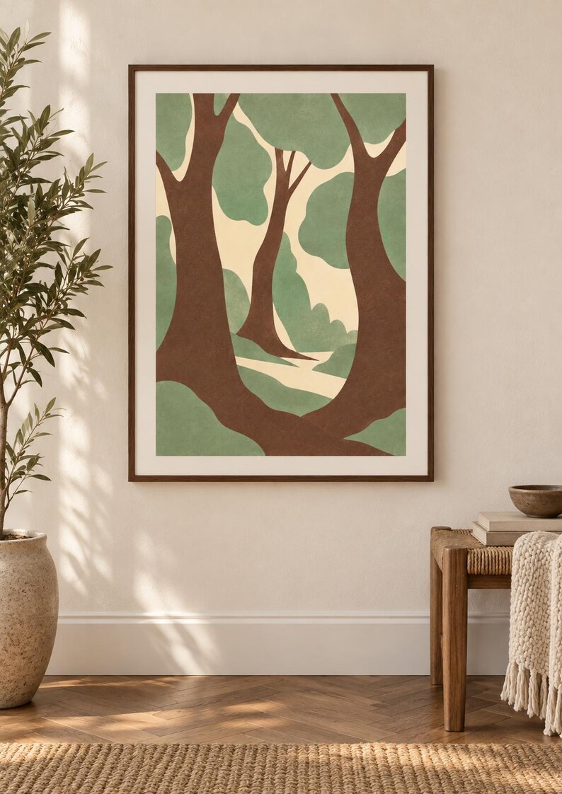 May include: A framed wall art print featuring a stylized forest scene with dark brown tree trunks, soft sage green foliage, and a cream-colored background. The artwork is enclosed in a thin, dark brown wooden frame and displayed on a wall.