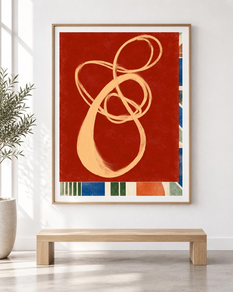 Pode incluir: Uma impress&atilde;o de arte de parede retangular emoldurada com um fundo vermelho profundo e um grande desenho de linha cont&iacute;nua em bege claro. A borda inferior exibe um padr&atilde;o de listras verticais azuis e verdes ao lado de um c&iacute;rculo laranja.