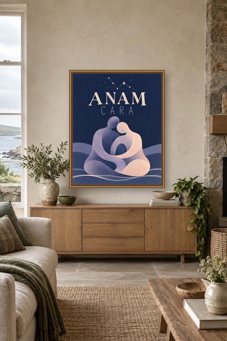 May include: A framed rectangular wall art print featuring a dark blue background with the text ANAM CARA in white. The illustration depicts two abstract figures in shades of purple and peach embracing, set against wavy lines with a star constellation above.