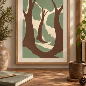 May include: A framed wall art print featuring a stylized forest scene with dark brown tree trunks and soft sage green foliage against a cream-colored background. The artwork is enclosed in a light-toned wooden frame with a white mat border.
