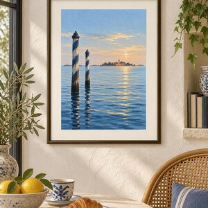 May include: A framed wall art print depicting a serene seascape with two blue and white striped wooden mooring poles rising from calm water. In the distance, a small island with buildings is visible under a soft, golden sunset sky with clouds.