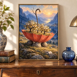May include: A framed wall art print depicting a surreal landscape where a large, open red umbrella rests on rocky ground, containing small flowering trees and a wooden staff. The background features a mountain range under a golden sunset sky.