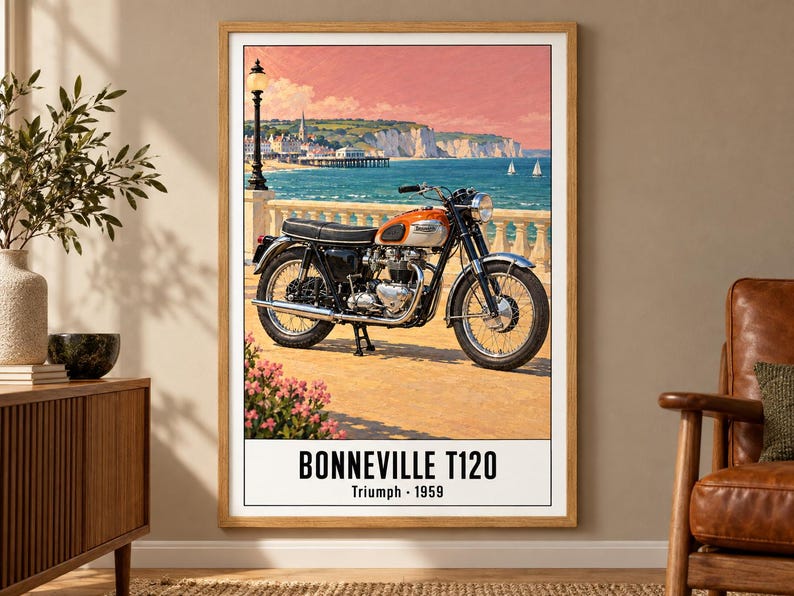May include: A framed wall art print featuring a vintage orange and silver Triumph Bonneville T120 motorcycle parked on a seaside promenade. The text at the bottom reads BONNEVILLE T120 Triumph 1959. The background shows a coastal town and ocean.