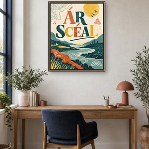 May include: A framed rectangular wall art print featuring a landscape illustration with a winding river, rolling hills, and a yellow sun. The text &Aacute;R SC&Eacute;AL is printed in large, bold, dark blue and orange letters at the top center of the artwork.