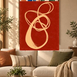 Pode incluir: Uma pe&ccedil;a de arte de parede retangular com um fundo vermelho profundo e uma grande pincelada cont&iacute;nua em bege claro, formando uma forma abstrata, em la&ccedil;o e entrela&ccedil;ada que ocupa o centro da tela vertical.