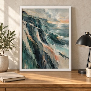 May include: A framed abstract painting depicting a coastal landscape with steep cliffs and crashing waves. The artwork features a palette of deep navy blue, teal, and soft peach tones, rendered with visible, textured brushstrokes in a vertical orientation.