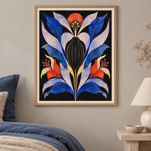 May include: A framed vertical wall art print featuring a symmetrical botanical illustration on a black background. The design displays stylised blue, light purple, and red leaves and flowers with thin gold lines and circular accents in a central motif.