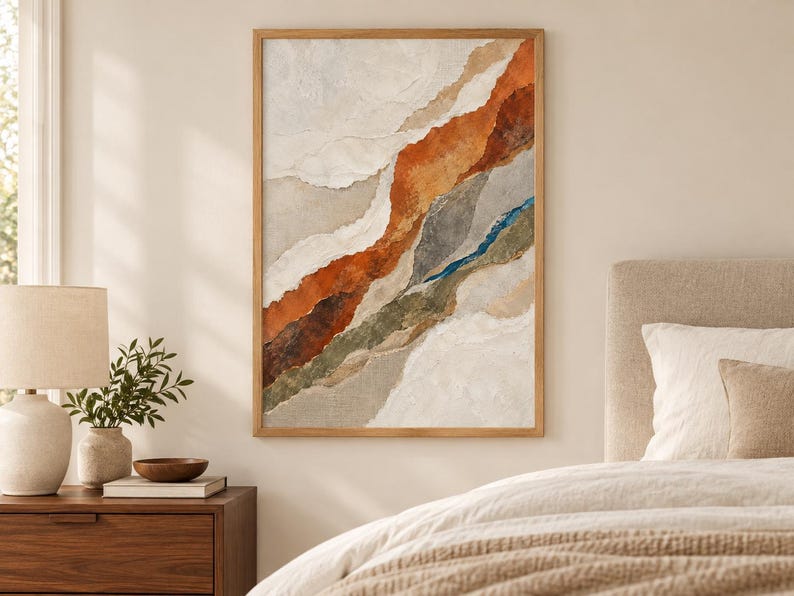 May include: A framed vertical wall art piece featuring an abstract composition of layered, torn-paper style textures in shades of burnt orange, deep brown, muted olive green, slate gray, and cream, accented by a thin, vibrant blue vertical line.