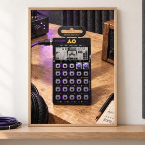 May include: A black Teenage Engineering PO-20 Arcade pocket operator synthesizer featuring a monochrome LCD screen, purple buttons, and two rotary knobs. The device is labeled with the text arcade and pocket operator, connected by a purple cable.