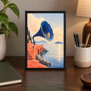 May include: A framed rectangular print featuring a surreal coastal scene with a large blue gramophone horn emerging from a red stone terrace. A small white sailboat is visible inside the horn, set against a calm sea, distant islands, and a sunset sky.