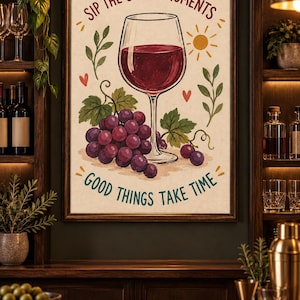 May include: A framed wall art print featuring a central illustration of a wine glass filled with red wine, surrounded by a cluster of purple grapes, green leaves, a small yellow sun, and red hearts. The text reads SIP THE SWEET MOMENTS and GOOD THINGS TAKE TIME.