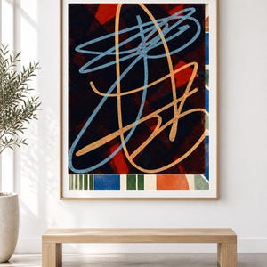 May include: A framed abstract wall art print featuring a dark background with overlapping red geometric shapes. The composition includes prominent light blue and tan continuous line drawings, with a bottom border of vertical stripes in blue, green, and orange.