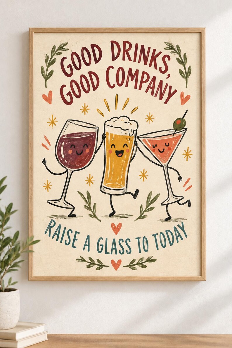 May include: A framed wall art print featuring a cartoon wine glass, beer glass, and martini glass with faces. The text reads "GOOD DRINKS, GOOD COMPANY" and "RAISE A GLASS TO TODAY" in red and blue. The background is cream with small orange hearts and stars.