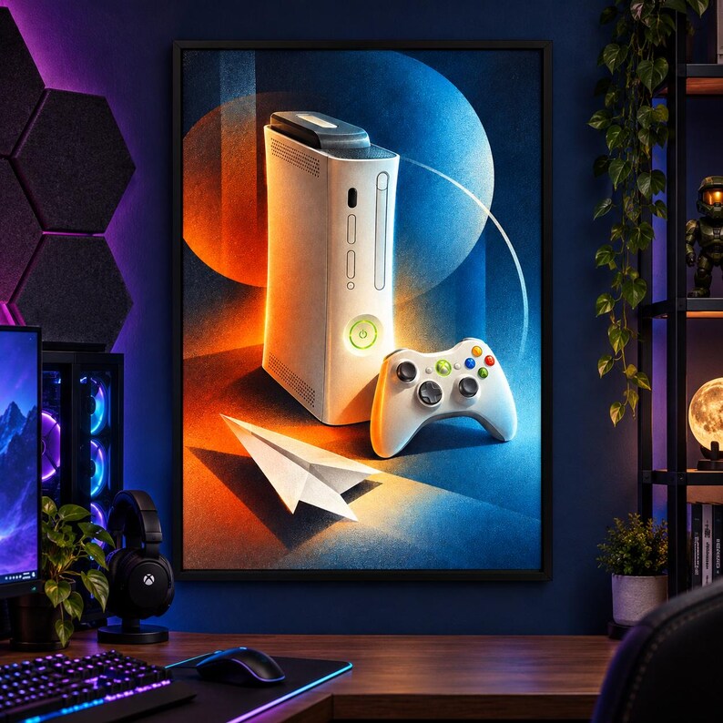 May include: A framed wall art print featuring a white video game console and a matching white wireless controller. A white paper airplane rests in the foreground. The background displays a vibrant abstract design with orange and blue circular shapes.