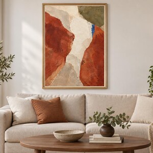 May include: A rectangular wall art piece in a light wood frame featuring an abstract composition with large, textured blocks of deep terracotta red, creamy off-white, muted olive green, and a small vertical accent of bright blue paint.