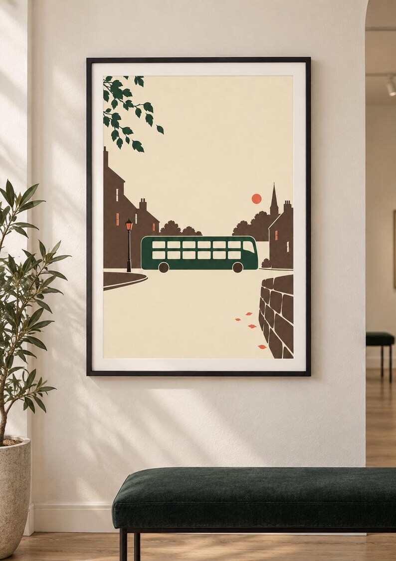 May include: A framed wall art print featuring a stylized illustration of a dark green double-decker bus driving through a town street. The scene includes brown silhouettes of buildings, a street lamp, a small red sun, and green tree leaves.