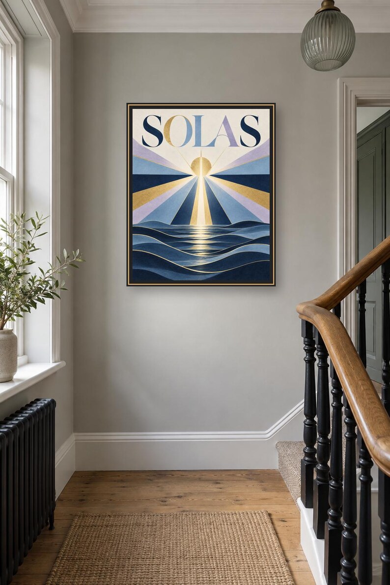 May include: A framed rectangular wall art print featuring the word SOLAS in bold dark blue letters at the top. Below the text, a stylized sun emits golden and blue rays over dark blue ocean waves, creating a geometric sunrise scene.