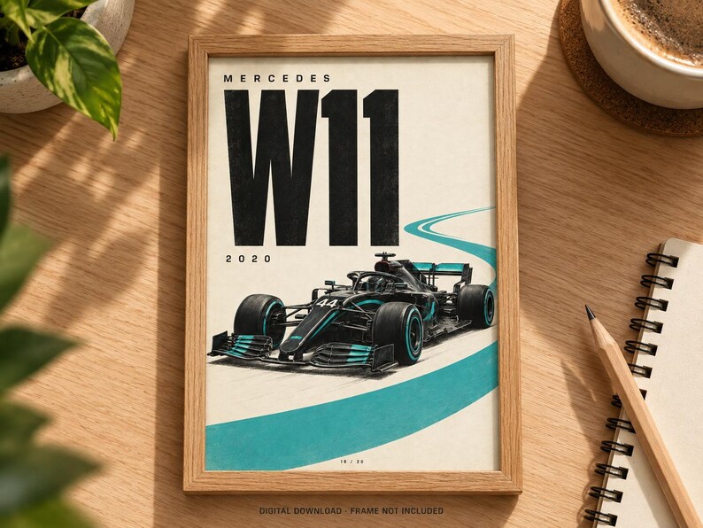 May include: A framed poster featuring a black Mercedes W11 Formula 1 race car with teal accents on a white background. The text reads MERCEDES W11 2020. A curved teal track line is visible behind the car. The frame is light wood.