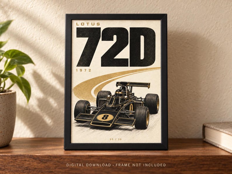 May include: A framed poster featuring a black and gold Lotus 72D Formula One race car with the number 8 on the nose. The text reads LOTUS 72D 1972 at the top and 05 / 20 at the bottom. The car is depicted on a stylized track against a cream background.
