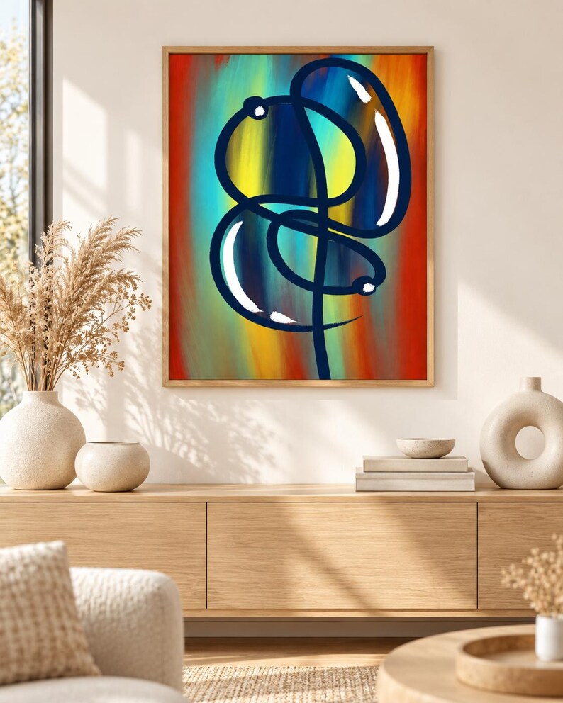 Pu&ograve; includere: Un'opera d'arte da parete incorniciata che presenta un disegno a linea continua blu scuro che forma una figura astratta simile a un palloncino. Lo sfondo &egrave; composto da pennellate verticali sfumate in tonalit&agrave; vivaci di rosso, arancione, giallo e verde acqua.