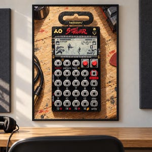 May include: A black Street Fighter themed pocket synthesiser featuring a digital display, a grid of sixteen numbered buttons, two red knobs, and various control labels. The device includes the text hadouken/ and Street Fighter printed on the front.