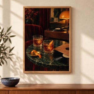 May include: A framed wall art print depicting a dark, moody interior scene with two crystal glasses filled with amber liquid and ice on a green marble table. A vinyl record, a record player, and a small brass dish with an orange peel are visible.