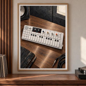 May include: A white portable synthesiser with a rectangular body, a small screen, multiple black and coloured circular knobs, and a white keyboard layout. The device features the text OP-1 printed on the right side of the chassis.