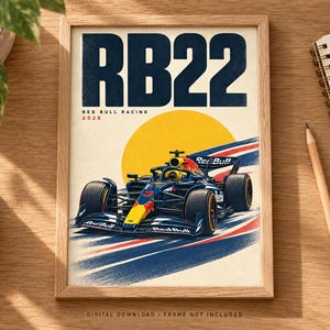 May include: A framed poster featuring a dark blue and yellow Red Bull Racing Formula 1 car with the number 3, set against a yellow sun and blue and red motion streaks. The text reads RB22, RED BULL RACING, and 2026. Digital download, frame not included.