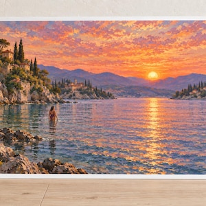 May include: A rectangular art print featuring a coastal landscape at sunset. The scene depicts a calm sea with a person wading in the water, rocky cliffs with Mediterranean-style buildings, distant mountains, and a vibrant orange and pink sky.