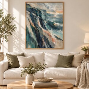 May include: A rectangular framed wall art piece featuring an abstract oil painting of a coastal landscape. The artwork displays deep navy, teal, and white brushstrokes depicting steep cliffs meeting the ocean with soft peach highlights.