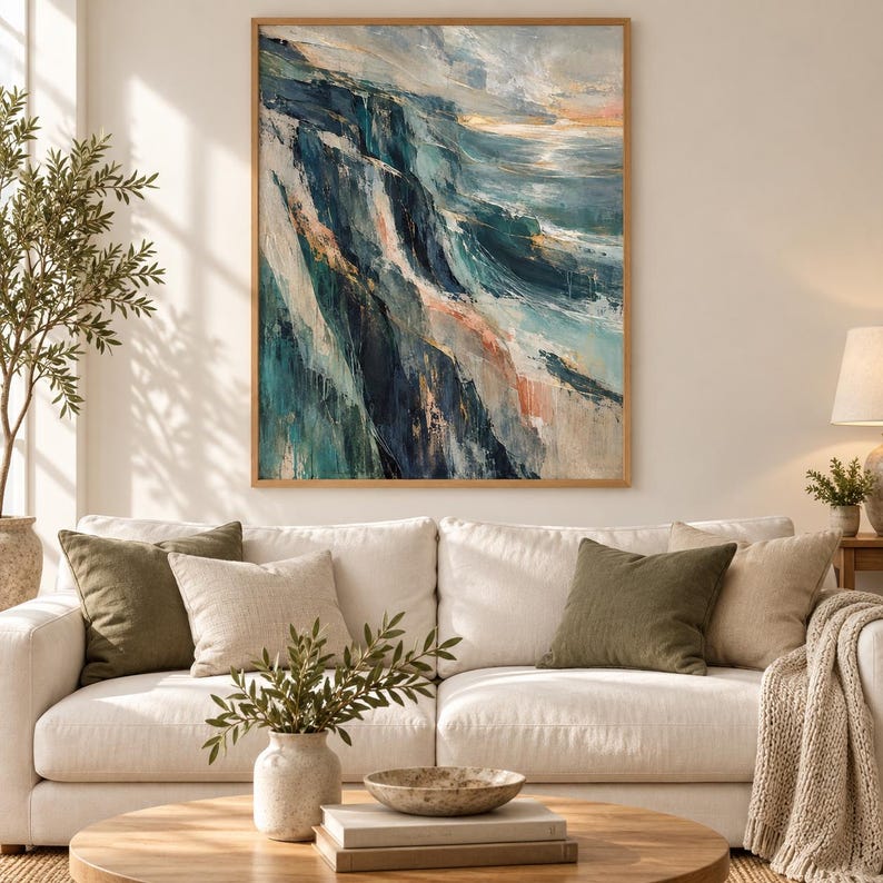 May include: A rectangular framed wall art piece featuring an abstract oil painting of a coastal landscape. The artwork displays deep navy, teal, and white brushstrokes depicting steep cliffs meeting the ocean with soft peach highlights.