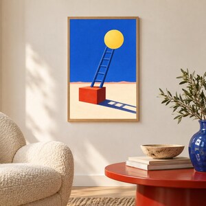 May include: A framed wall art print featuring a surreal landscape with a bright yellow circle suspended in a deep blue sky above a red cube. A blue ladder leans against the cube, which sits on a light beige ground with a long, dark blue shadow.