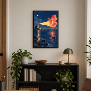 May include: A framed wall art print depicting a lighthouse on a rocky shore at night. The lighthouse emits a bright, orange, flower-shaped beam of light across the dark blue ocean. A full moon is visible in the starry sky above the horizon.
