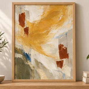 May include: An abstract painting in a light wood frame featuring a textured composition of mustard yellow, burnt orange, cream, and sage green brushstrokes. The artwork displays layered paint applications with visible depth and varied colour blocks.