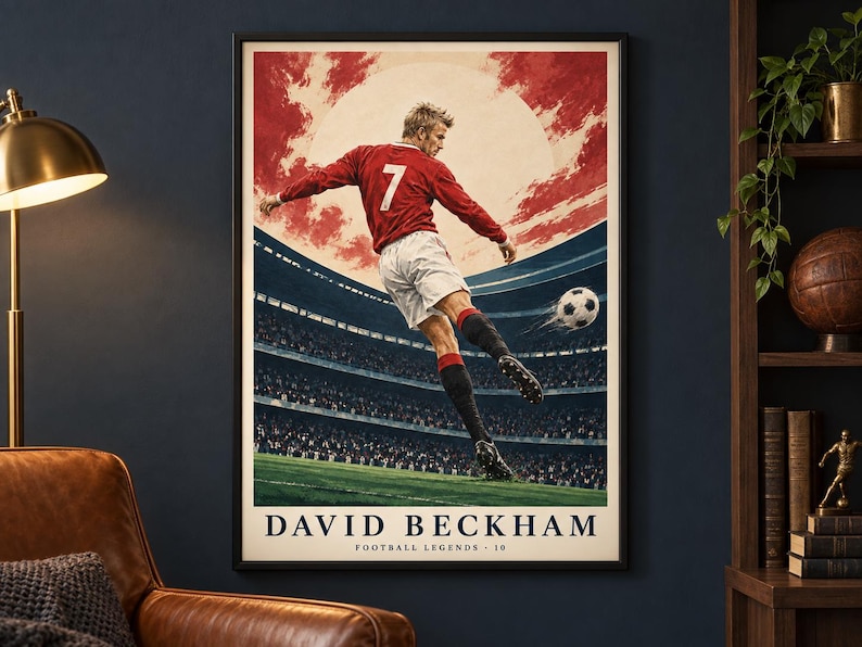 May include: A framed poster featuring a soccer player in a red jersey with the number 7 and white shorts kicking a soccer ball in a stadium. The background shows a red sky and a large sun. The text reads DAVID BECKHAM FOOTBALL LEGENDS 10.