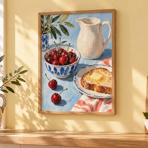 May include: A framed wall art print depicting a still life painting of a white pitcher, a blue and white patterned bowl filled with red cherries, and a plate with a slice of buttered bread on a blue surface with a red and white striped cloth.