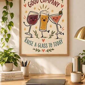 May include: A framed wall art print featuring a cartoon illustration of a wine glass, a beer glass, and a martini glass with faces. The text reads Good Drinks, Good Company and Raise a Glass to Today, accented with small stars, hearts, and leaves.