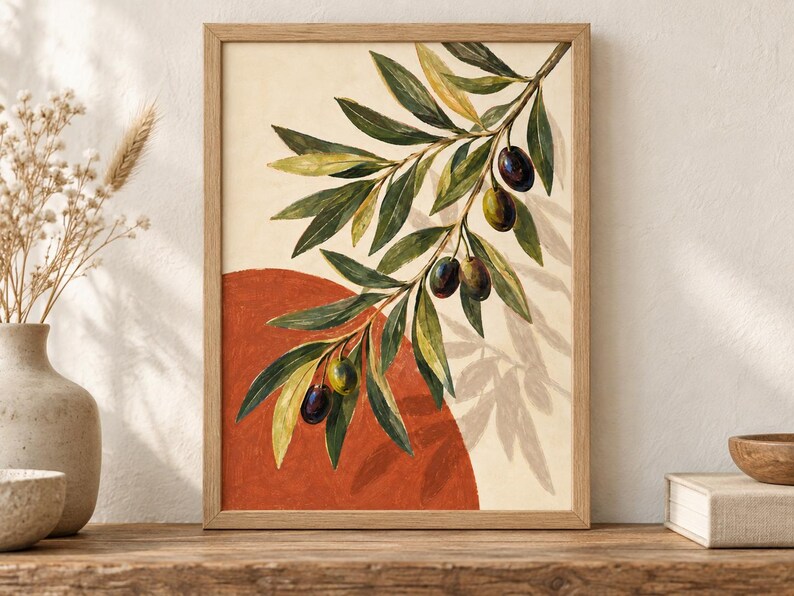 May include: A framed wall art print featuring a watercolor illustration of an olive branch with green and dark purple olives. The branch is set against a cream background with a large, solid terracotta-colored circle behind the foliage.